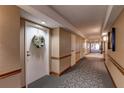 Inviting hallway with neutral tones, patterned carpet, and a welcoming front door wreath at 2333 Feather Sound Drive # A409, Clearwater, FL 33762