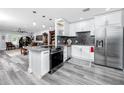 Modern kitchen with stainless steel appliances, granite countertops, and sleek white cabinets at 2430 Florentine Way # 40, Clearwater, FL 33763