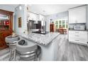 Modern kitchen with granite countertops, white cabinets, stainless steel appliances, and eat in breakfast nook at 2430 Florentine Way # 40, Clearwater, FL 33763