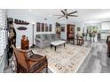 Comfortable living room featuring cozy seating, wood-look floors, and a ceiling fan at 2430 Florentine Way # 40, Clearwater, FL 33763
