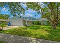 Charming single-Gathering home with a well-maintained lawn and colorful exterior design at 2533 Blossom Lake Dr, Holiday, FL 34691