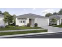 Inviting one-story house with a well-maintained lawn, a two-car garage and a clean design at 2791 Peake St, North Port, FL 34286