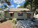 Rear view of a single-story home featuring a brown door and windows with awnings at 2800 13Th N Ave, St Petersburg, FL 33713