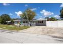 Charming single-story home with well-maintained lawn, complemented by lush landscaping and inviting curb appeal at 400 53Rd N St, St Petersburg, FL 33710