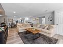 Bright and airy living room featuring wood-look flooring, comfortable seating, and open floor plan at 4460 67Th N St, St Petersburg, FL 33709