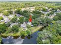 Aerial view of a private pool surrounded by a lush backyard and the lake at 4639 Cabbage Palm Dr, Valrico, FL 33596