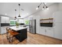 Modern kitchen features stainless steel appliances, marble countertops, and an island with seating at 4639 Cabbage Palm Dr, Valrico, FL 33596