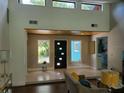 Open and bright foyer with high ceilings, modern lighting, and a view to the exterior at 5017 E 127Th Ave, Temple Terrace, FL 33617