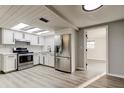 Modern kitchen with stainless steel appliances, white cabinets, and a bright, inviting atmosphere at 7031 Magnolia Valley Dr, New Port Richey, FL 34653