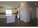 Modern kitchen featuring stainless steel appliances, dark floors, white cabinetry and island at 719 Allora Ave, Nokomis, FL 34275