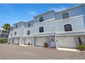 Three-story townhome exterior with garage and a charming door at 751 Pinellas Bayway S # 104, St Petersburg, FL 33715
