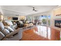 Spacious living room with fireplace, comfortable seating, and access to a balcony at 751 Pinellas Bayway S # 104, St Petersburg, FL 33715