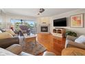 Cozy living room featuring a fireplace and a sliding glass door to balcony at 751 Pinellas Bayway S # 104, St Petersburg, FL 33715