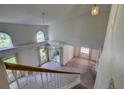 Spacious living room featuring vaulted ceilings, large windows, and a staircase at 8990 Antigua Dr, Seminole, FL 33777