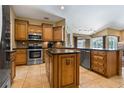 Well-equipped kitchen featuring stainless steel appliances, granite countertops, and a convenient center island at 1046 Middlesex Dr, New Port Richey, FL 34655