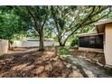 Spacious backyard featuring mature trees and a screened-in porch, offering privacy and shade at 11783 102Nd Ave, Largo, FL 33778