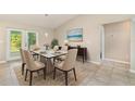 Dining area featuring a glass-topped table, seating for six, and sliding door access to the lanai at 13116 Marathon Blvd, Port Charlotte, FL 33981