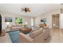 Bright living room featuring vaulted ceilings, tile flooring, and comfortable neutral furnishings at 13116 Marathon Blvd, Port Charlotte, FL 33981