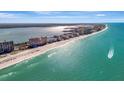 Breathtaking aerial view of beachfront condos along the pristine turquoise coastline at 1340 Gulf Blvd # 12A, Clearwater Beach, FL 33767