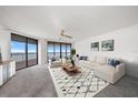 Bright living room with neutral colors, modern furniture, ocean views, and a decorative area rug at 1340 Gulf Blvd # 12A, Clearwater Beach, FL 33767