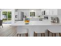 Modern kitchen with stainless steel appliances, white cabinets, and breakfast bar at 1826 2Nd E Ave, Bradenton, FL 34208