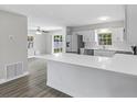 Open-concept kitchen featuring stainless appliances, white cabinets and island seating at 1826 2Nd E Ave, Bradenton, FL 34208