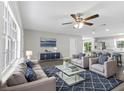 Bright living room with modern furnishings, hardwood floors, and large windows at 1826 2Nd E Ave, Bradenton, FL 34208