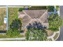 Aerial view of a well-maintained property with a lush green lawn, a fenced backyard, and mature trees at 18339 Fish Loop, Land O Lakes, FL 34638