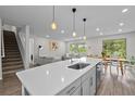 Spacious kitchen with an island, dining area, and views of the living room and the staircase at 19259 Mossy Pine Dr, Tampa, FL 33647
