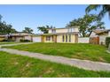 Traditional two-story home with a well-maintained lawn at 1972 Lansing Dr, Clearwater, FL 33763