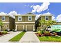 Attractive townhome exteriors displaying lush lawns, colorful flower beds, and convenient driveways at 2119 Broadway View Ave, Brandon, FL 33510