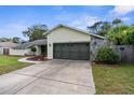 Charming single-story home featuring a well-maintained lawn and a two-car garage at 2319 Canfield Dr, Spring Hill, FL 34609