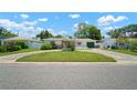 Lovely single-story home with green garage door, circular driveway, and well-maintained front yard at 2502 Tropical Shores Se Dr, St Petersburg, FL 33705