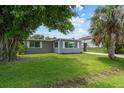 The exterior of this house is newly painted and has a well-maintained lawn at 2701 Camellia Ter, Punta Gorda, FL 33950