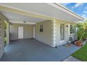 Covered carport featuring direct access to the home and additional storage space at 296 Huntington Dr, Largo, FL 33771