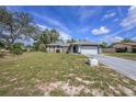 Charming single-story home with a two-car garage and a spacious front lawn at 3009 Ainsworth Ave, Spring Hill, FL 34609