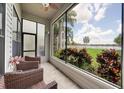 Comfortable screened porch with seating and serene views of the yard and water at 3127 W Sligh Ave # 101C, Tampa, FL 33614