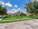 View of the home's back exterior featuring a screened lanai and mature trees, creating a private backyard at 3503 Graycliff Ln, Brandon, FL 33511