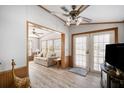 Cozy living room featuring wood-look flooring, ceiling fan, and comfortable sofa at 35045 Cynthia Ave # 35945, Zephyrhills, FL 33541