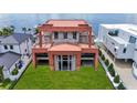 Waterfront new construction featuring a modern exterior, spacious lawn, and proximity to the water at 3611 Bayshore Ne Blvd, St Petersburg, FL 33703