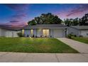 Charming single-story home with a well-manicured lawn during twilight hours at 3733 Mendocino St, New Port Richey, FL 34655