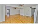 Spacious living room with gleaming hardwood floors, lots of natural light, and an open floor plan at 3906 W San Luis St, Tampa, FL 33629