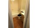 Cozy bathroom with tub, shower, and wood-look flooring at 39132 County Road 54 Rd # G 2164, Zephyrhills, FL 33542