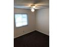 Carpeted bedroom with ceiling fan and window providing natural light at 39132 County Road 54 Rd # G 2164, Zephyrhills, FL 33542