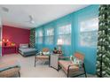 Bright and sunny florida room with colorful decorations, drapes and a ceiling fan at 500 Glennes Ln # 202, Dunedin, FL 34698