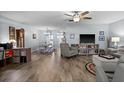 Open-concept living area with wood floors, a ceiling fan, and ample space for relaxation and entertainment at 5660 80Th N St # B106, St Petersburg, FL 33709