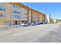 Multi-story condo building with parking and a stone pillar at 5820 N Church Ave # 147, Tampa, FL 33614