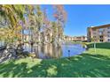 Scenic pond with fountain, lush landscaping, and building in the background at 5820 N Church Ave # 147, Tampa, FL 33614
