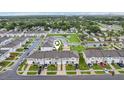 Aerial view showcases community layout with pond, green spaces, and well-maintained townhomes at 6235 Bucket Ct, Gibsonton, FL 33534