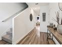Hallway boasts wood-look floors, staircase, and flows to other rooms in the home at 6235 Bucket Ct, Gibsonton, FL 33534